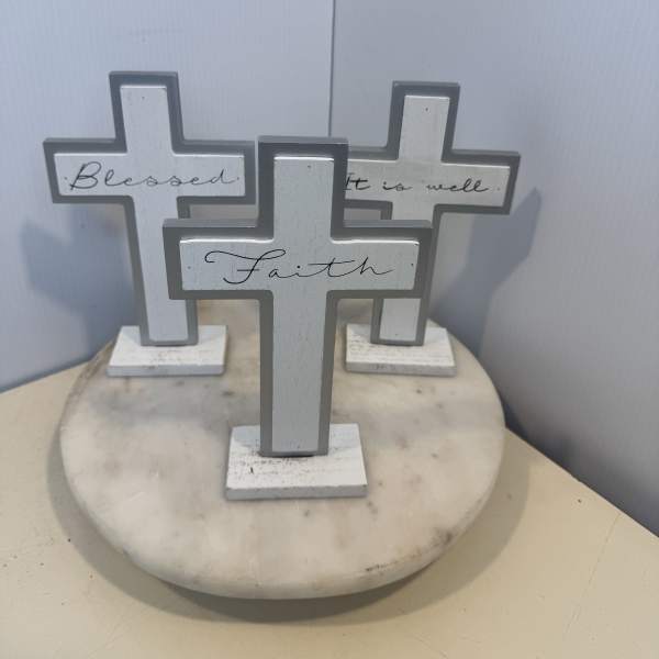 Three decorative cross signs on a round marble base