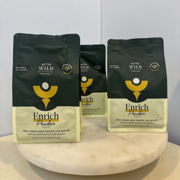 Three bags of plant food on a round pedestal