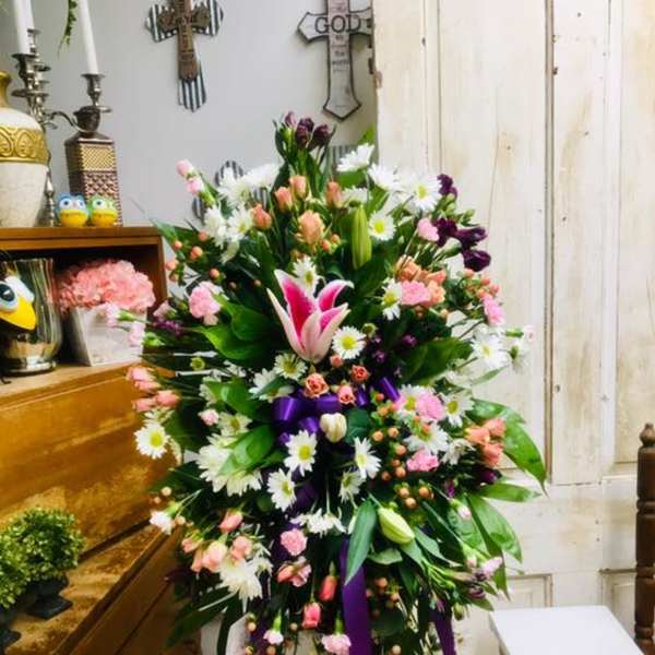 Tall standing floral spray with pink, white, and purple flowers