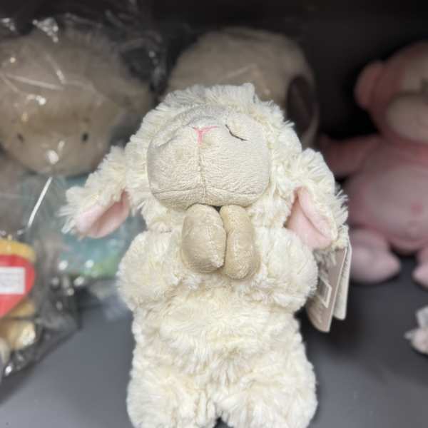 Plush cream-colored lamb toy with pink ears