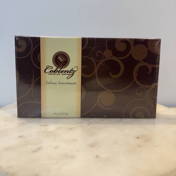 Box of assorted chocolates in brown and cream packaging