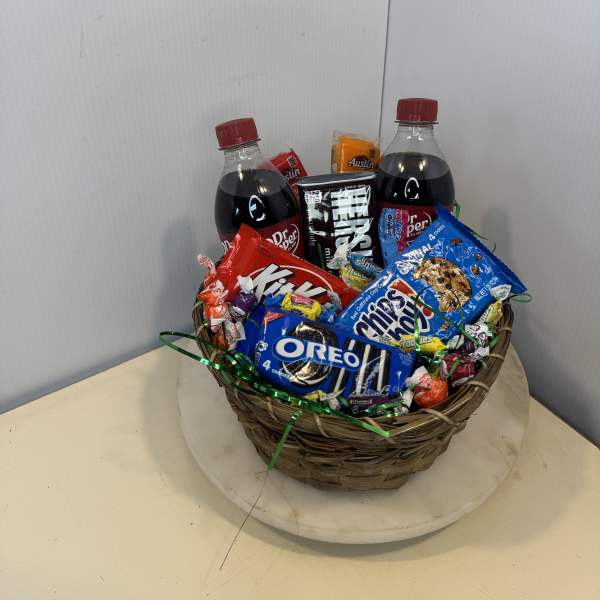 Basket of soda bottles and assorted candy and cookies