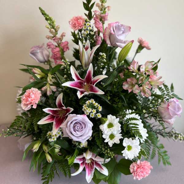 Bouquet of pink and lavender flowers with lilies and roses