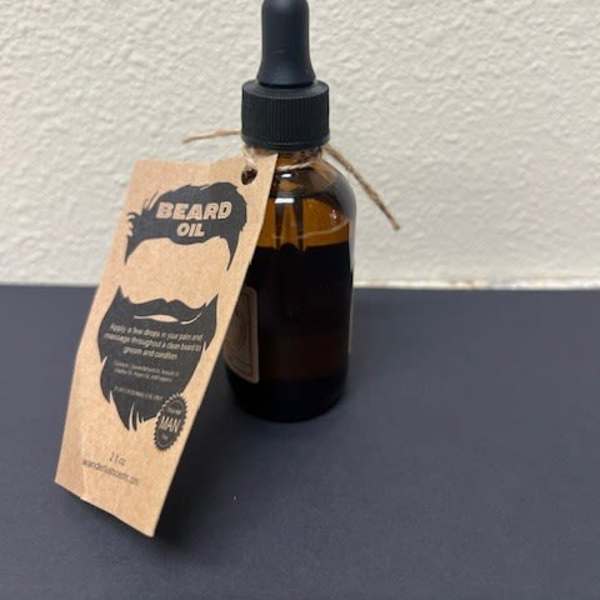 Amber dropper bottle labeled beard oil with a hanging tag