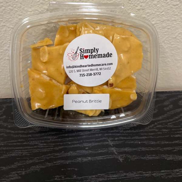 Plastic clamshell container of peanut brittle with a label