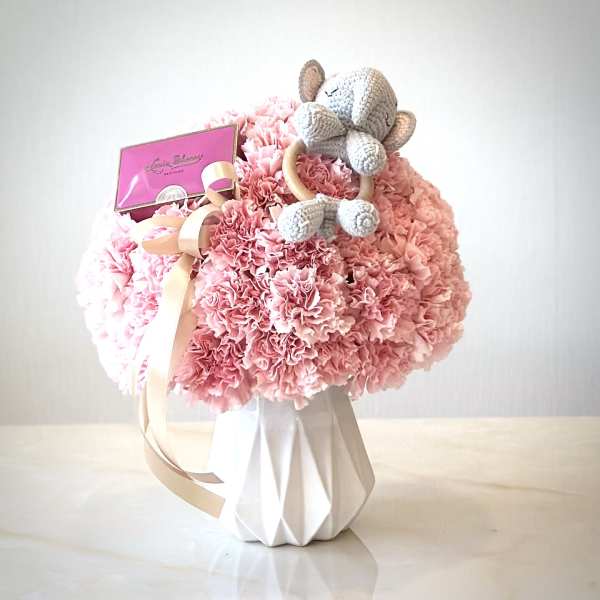 Pink carnation bouquet with a crocheted teddy bear and gift card