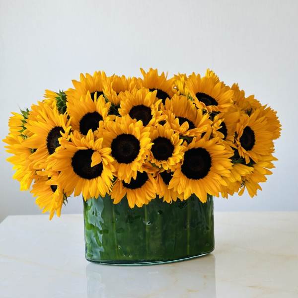 Sunflower bouquet in a green glass vase