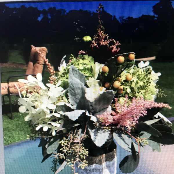 Mixed floral arrangement in a glass vase with white blooms and pink accents