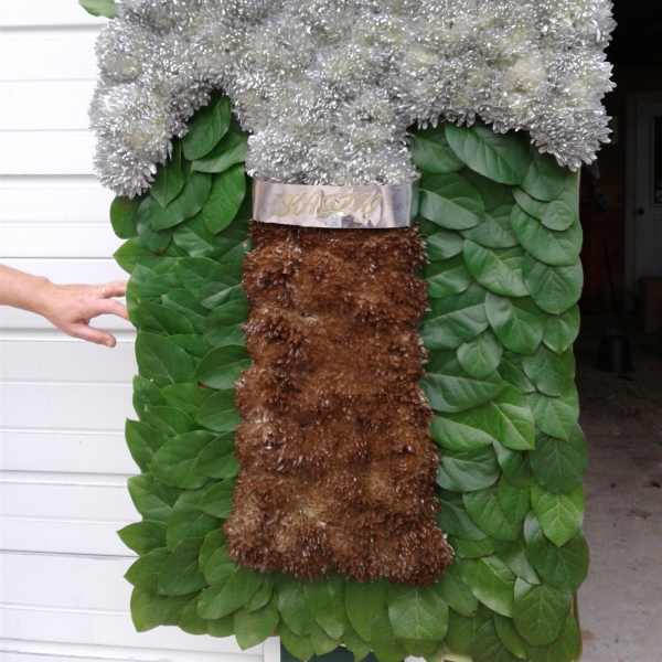 Large floral standing spray with silver blooms and green foliage