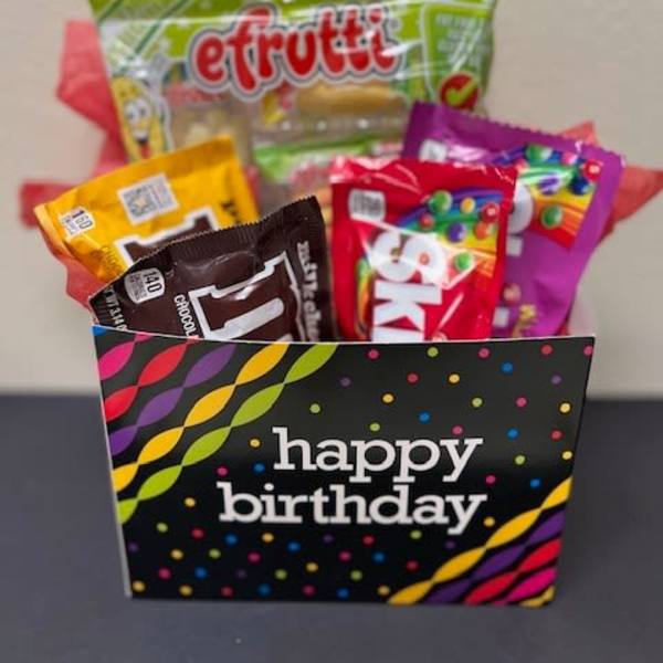 Birthday gift bag filled with assorted candy packages