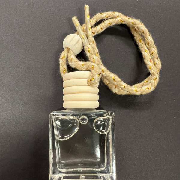 Clear glass car air freshener bottle with a braided hanging cord