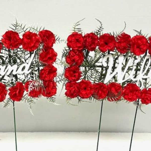 Red floral signs reading Husband and Wife