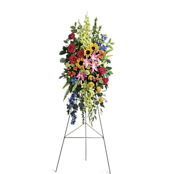 Standing floral spray with mixed flowers on an easel