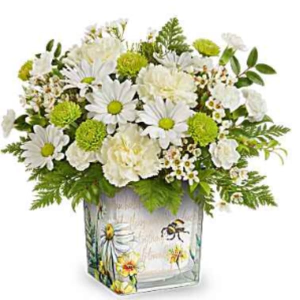 White daisies and green pom flowers in a painted glass vase