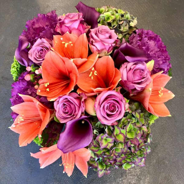 Bouquet of orange lilies, purple roses, and calla lilies