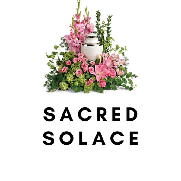 Pink floral funeral arrangement with a silver urn