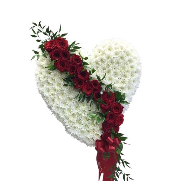 Heart-shaped white floral arrangement with a diagonal line of red roses