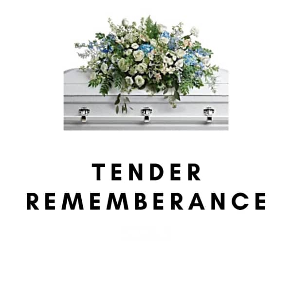 White and blue floral casket spray on a white casket