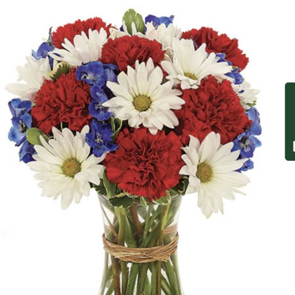 Red carnations and white daisies in a glass vase with blue accents