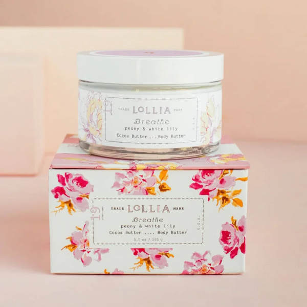 Jar of body butter on a floral-patterned box