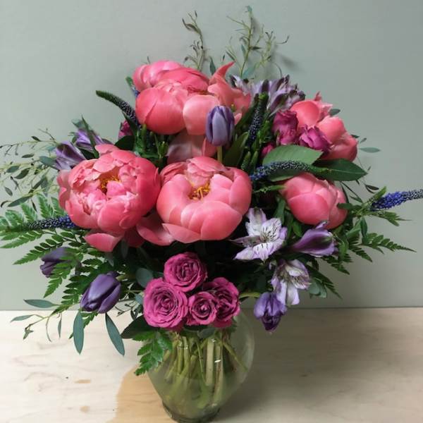 Pink and purple mixed bouquet in a clear glass vase