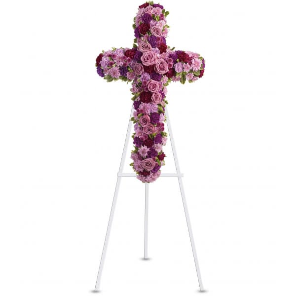 Purple and pink floral cross on a white easel