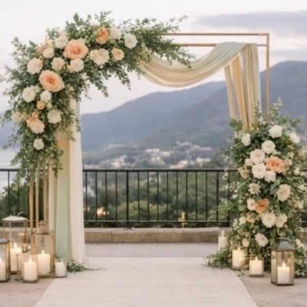 Floral wedding arch with peach and white roses and draped fabric