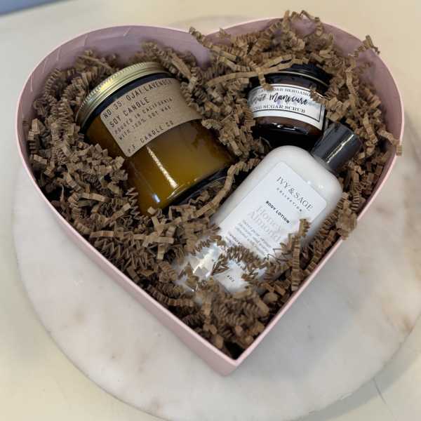 Heart-shaped gift box with candles, body lotion, and sugar scrub