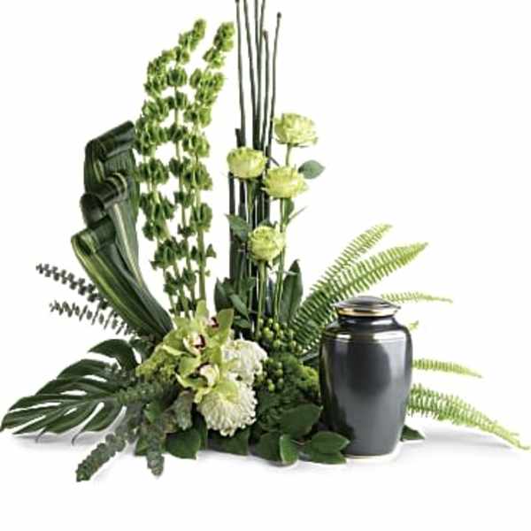 Green floral arrangement with a black urn vase