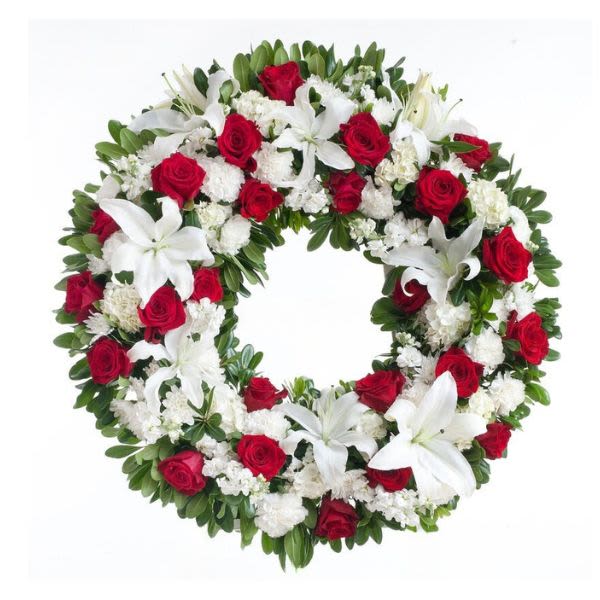Heart-shaped wreath of red roses and white lilies