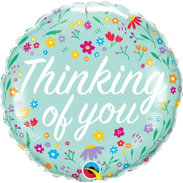 Round mint-green balloon with floral print and the words "Thinking of you"