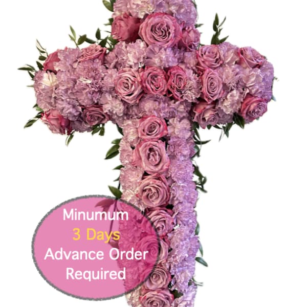 Cross-shaped floral arrangement of pink and lavender roses and carnations
