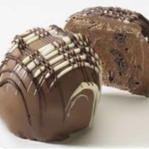 Chocolate loaf cake with chocolate drizzle and a sliced piece behind it