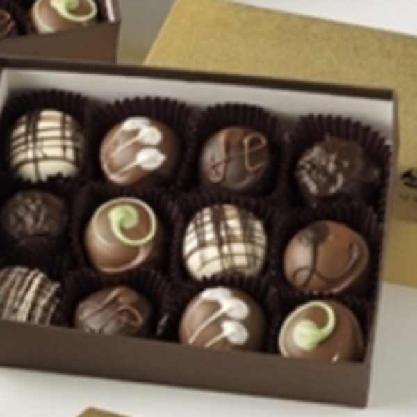 Box of assorted decorated chocolates in paper cups