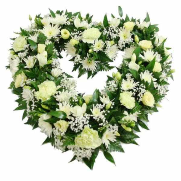 Heart-shaped white floral wreath with green foliage