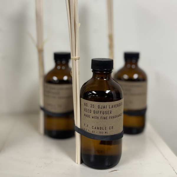 Amber reed diffuser bottles with black caps and reed sticks