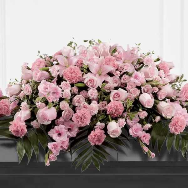 Large pink floral casket spray with lilies and roses