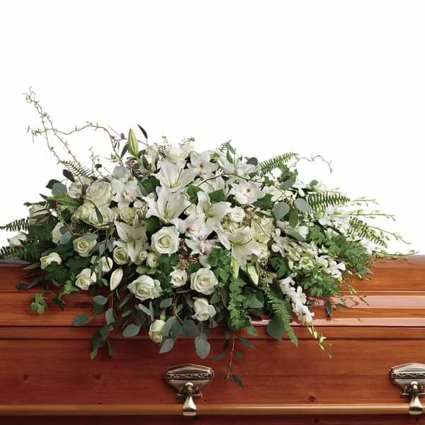 White floral casket spray with roses and lilies