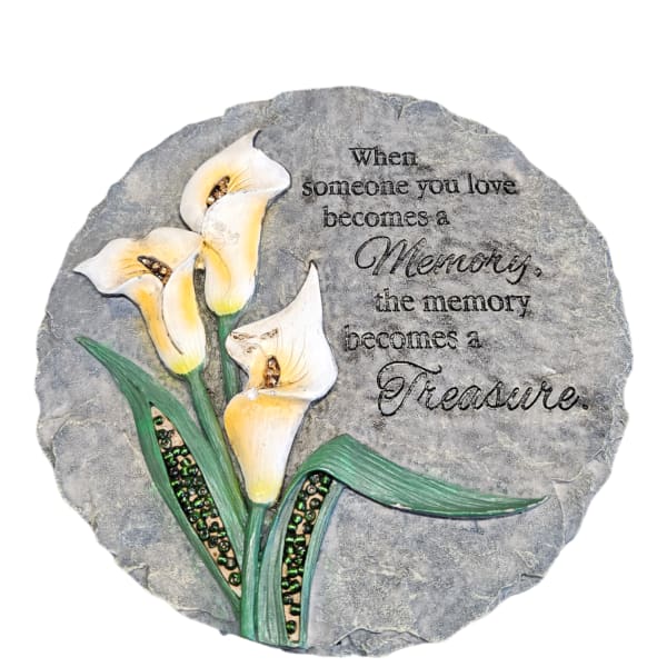 Stone plaque with white calla lilies and a memorial quote
