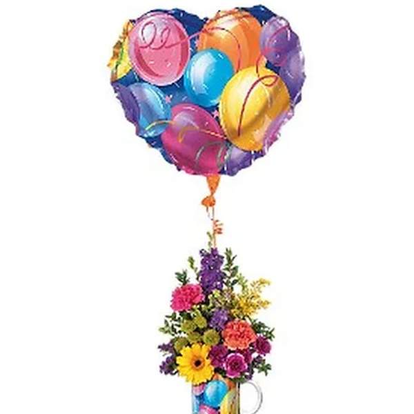 Heart-shaped balloon above a colorful flower arrangement in a mug