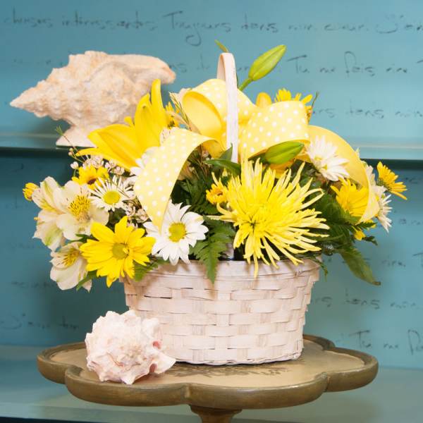 Yellow and white flower basket with ribbon and seashells