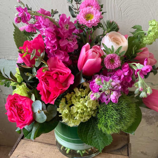 Bright pink and purple mixed bouquet in a glass vase