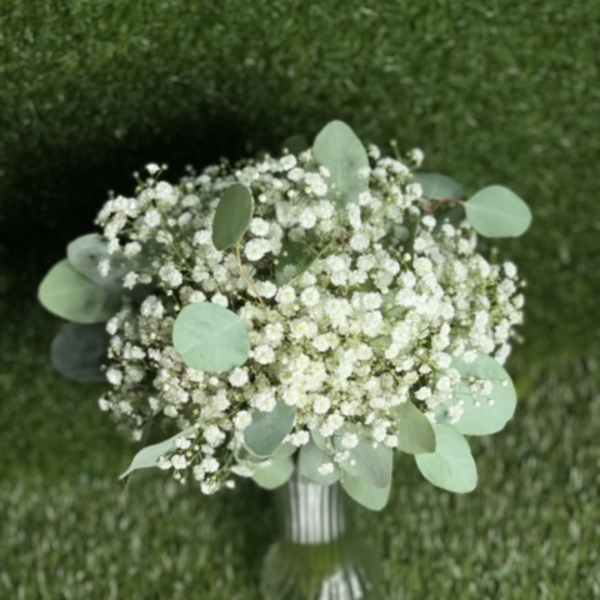 White baby's breath bouquet with eucalyptus in a glass vase