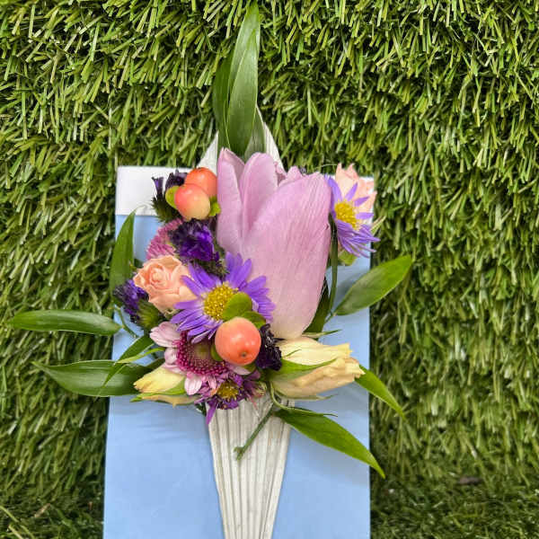 Small bouquet with pink tulip and purple flowers in a white wrap