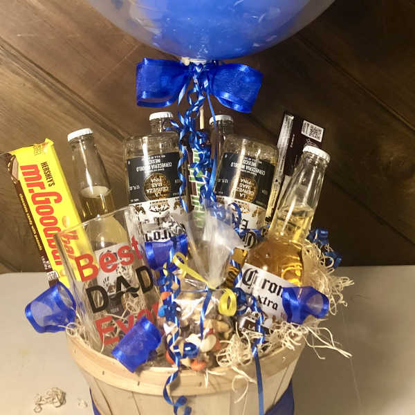 Gift basket with beer bottles, candy, and a large blue balloon