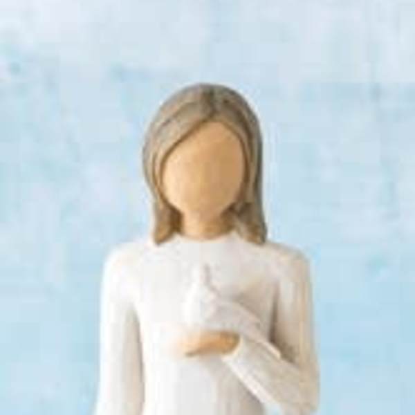 White angel figurine in a long dress against a blue background