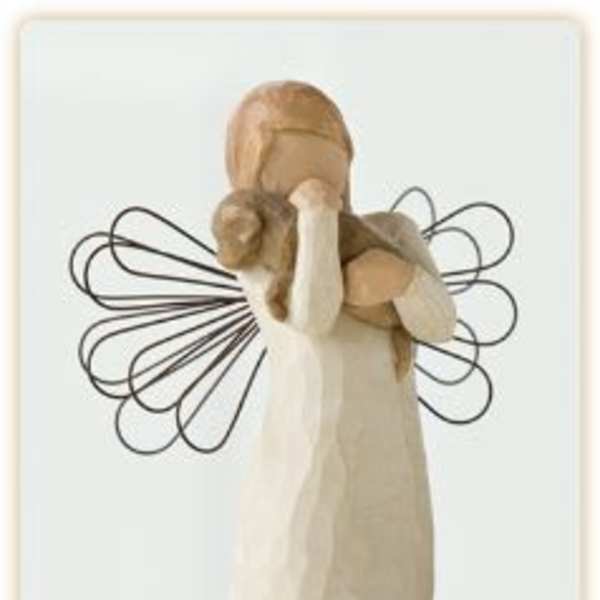 Wooden angel figurine with wire wings and a long cream dress