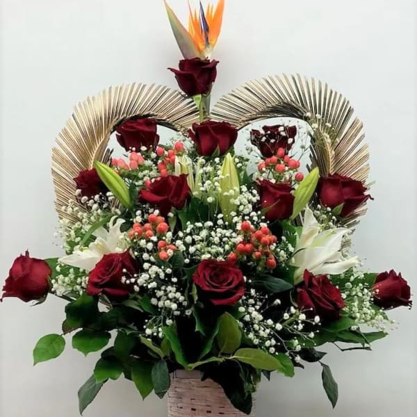 Basket arrangement of red roses, white lilies, and bird of paradise