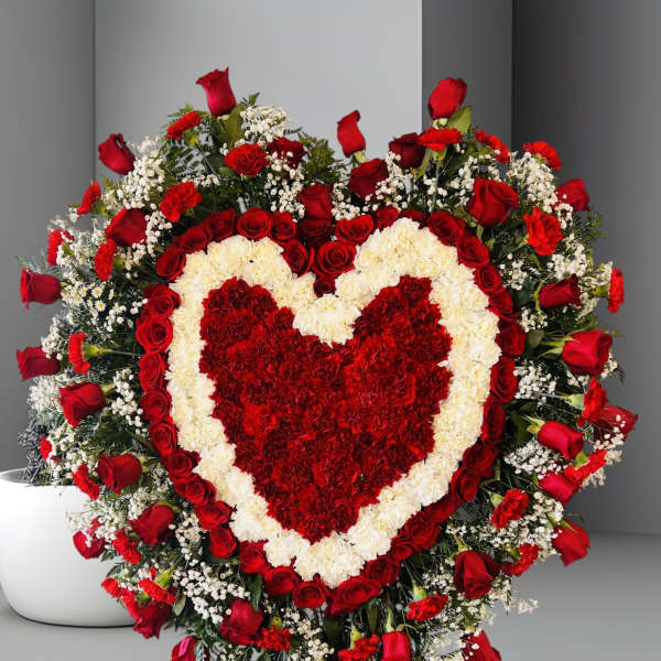 Heart-shaped red and white floral standing spray with roses