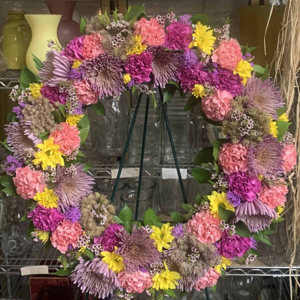 Heart-shaped floral wreath with pink, purple, and yellow flowers